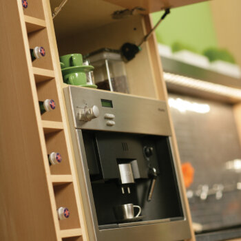A wine rack and wall hinge top cabinet combined to create a custom beverage center.